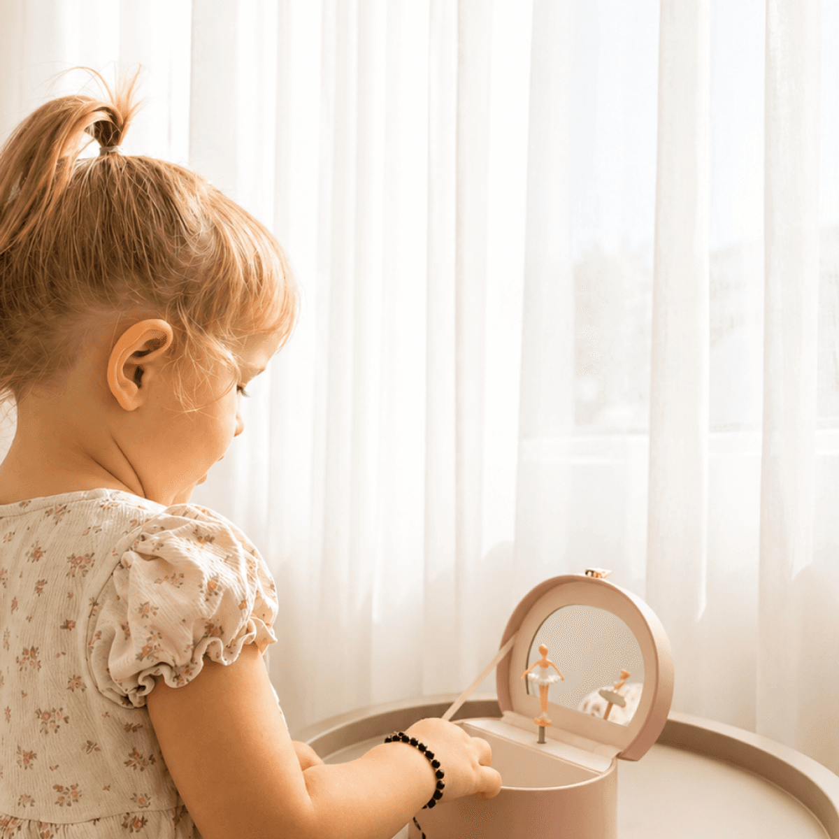 Little girl playing with a musical ballerina jewelry box